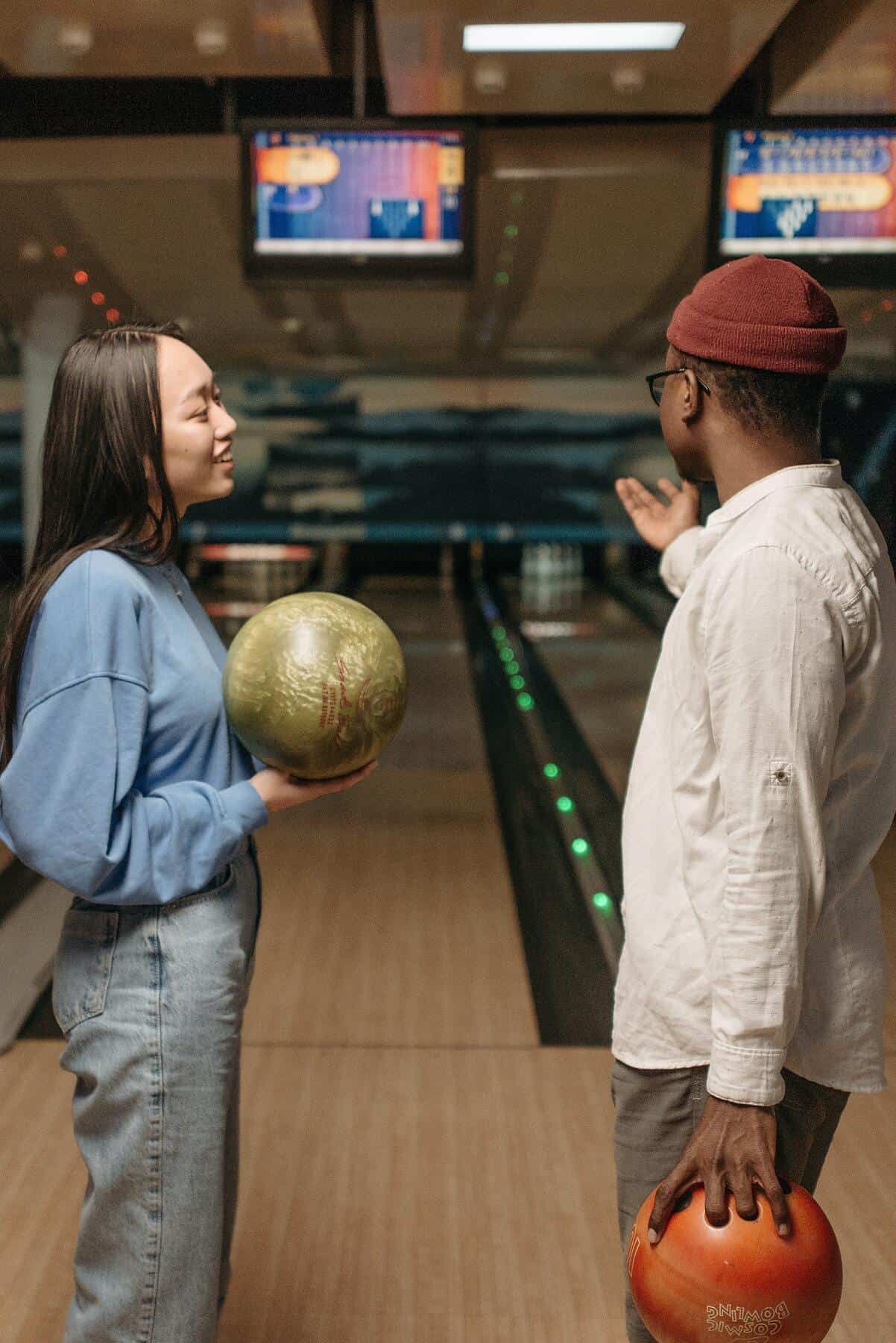 man and woman discussing in front of bowling alley